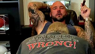 Jason Collins, the muscular biker, enjoys a blowjob while smoking a cigar.