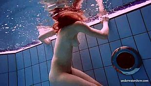 redhead marketa in a white dress in the pool