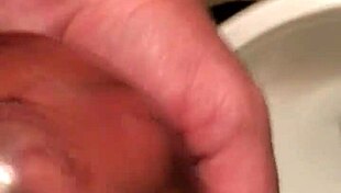 In this condom piss series part two, he fills the rubber with his urine.