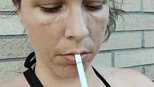 kelly kendricks smokes in the sun, showing lots of cleavage 😎