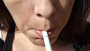 kelly kendricks smokes in the sun, showing lots of cleavage 😎