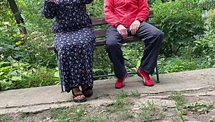 Mature woman handles huge shaft outdoors into glass