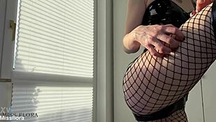 dominant babe worships her own latex-clad ass in fishnets and boots teasing softcore femdom style