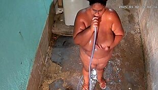hidden cam catches stepmom bathing and flashing huge tits in backyard shower